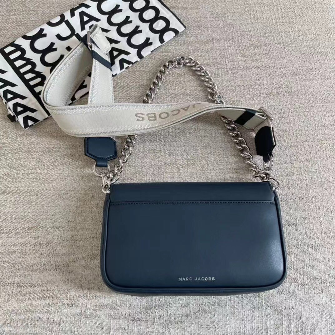 Navy blue leather shoulder bag with silver-tone chain, adjustable fabric strap, and statement buckle – a timeless luxury handbag for any occasion.