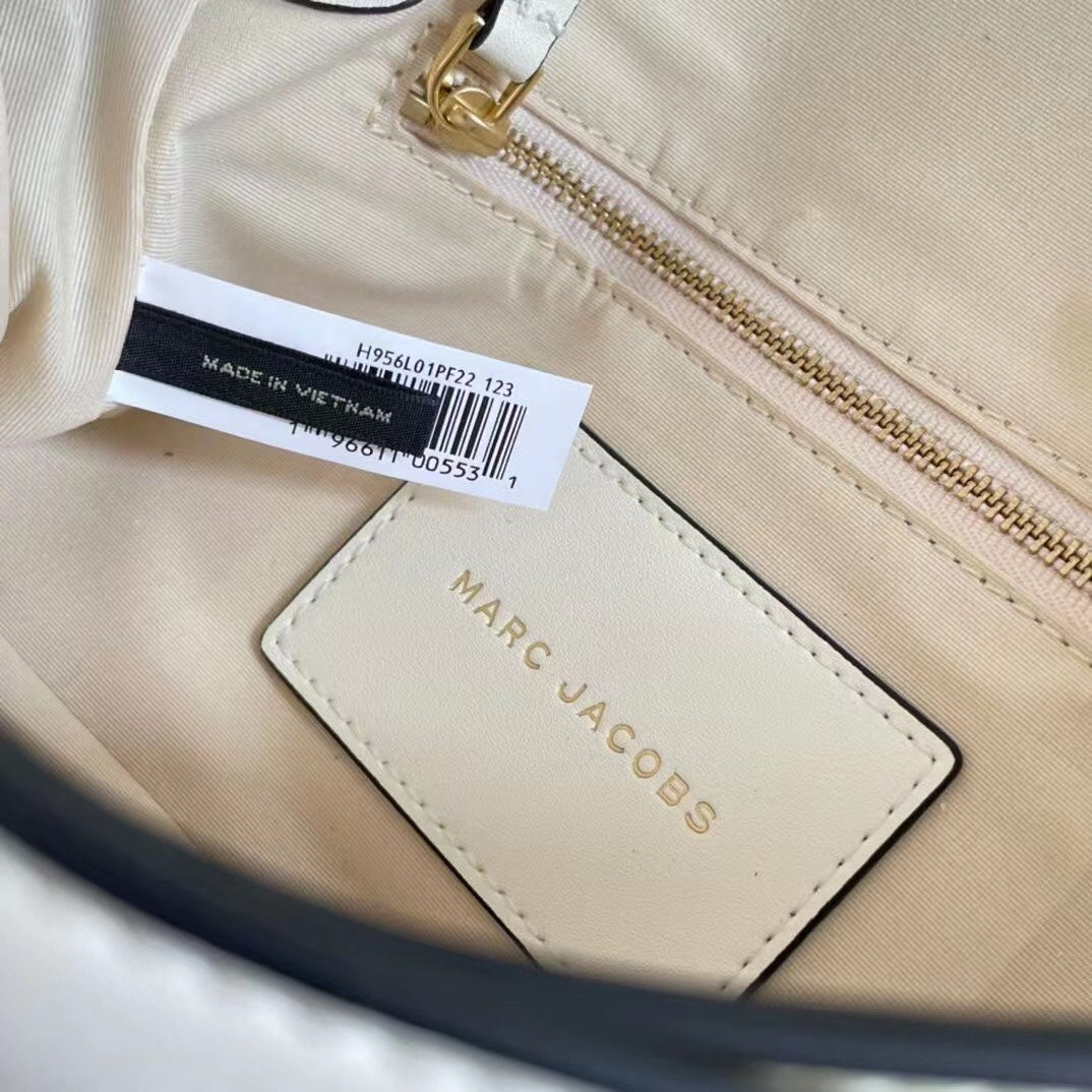 Ivory leather shoulder bag with gold-tone chain, adjustable fabric strap, and statement buckle – a modern minimalist handbag for every occasion