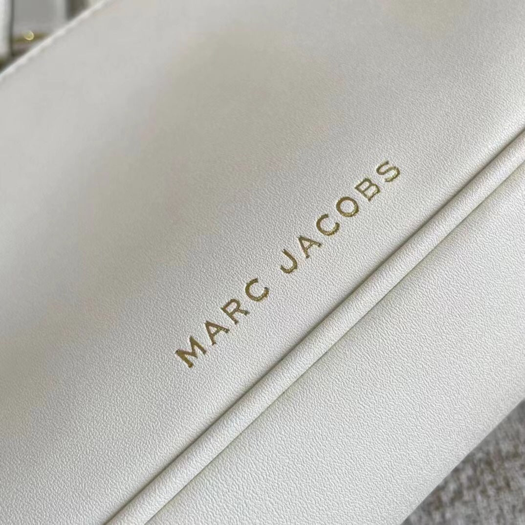 Ivory leather shoulder bag with gold-tone chain, adjustable fabric strap, and statement buckle – a modern minimalist handbag for every occasion