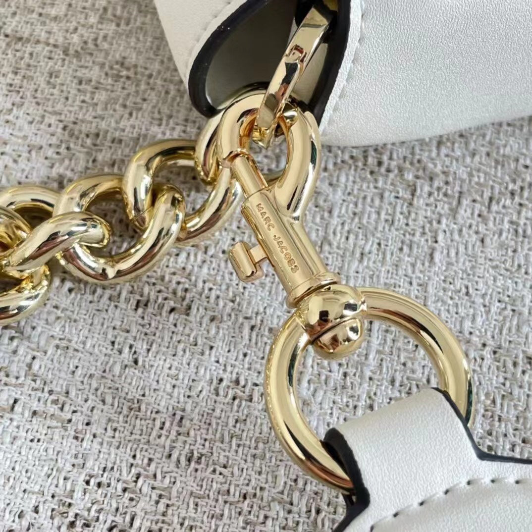 Ivory leather shoulder bag with gold-tone chain, adjustable fabric strap, and statement buckle – a modern minimalist handbag for every occasion