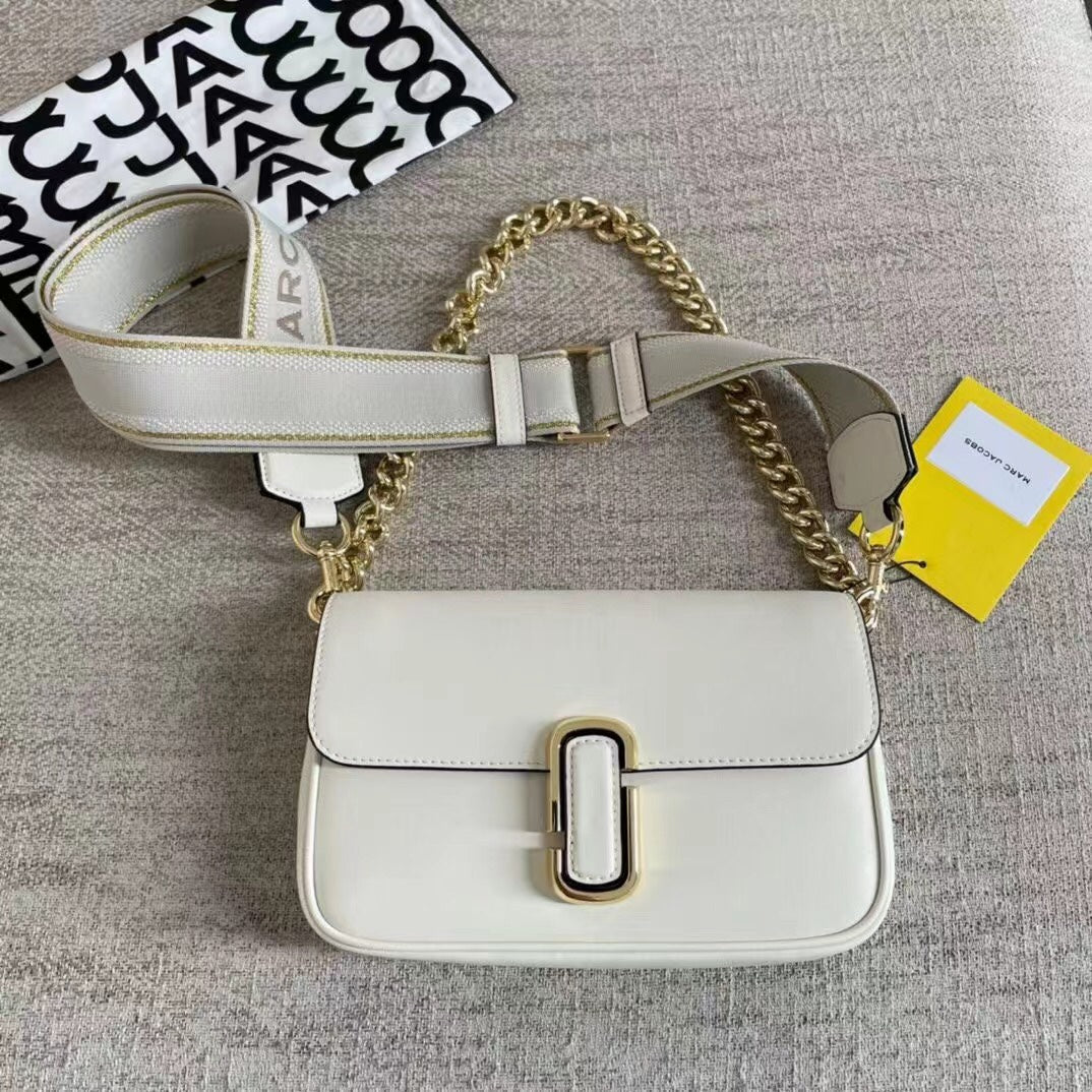 Ivory leather shoulder bag with gold-tone chain, adjustable fabric strap, and statement buckle – a modern minimalist handbag for every occasion